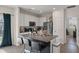 Modern kitchen features white cabinets, stainless steel appliances, and a granite-topped island with barstool seating at 394 Flyway Rd, Goose Creek, SC 29445