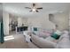 Open-concept living space with a comfortable sectional sofa, kitchen island, and wood-look flooring at 394 Flyway Rd, Goose Creek, SC 29445