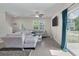 Bright and airy living room with large sectional sofa, wood-look flooring, and a view of the neighborhood at 394 Flyway Rd, Goose Creek, SC 29445