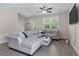 Comfortable living room with a large sectional sofa, ceiling fan, and natural light from the windows at 394 Flyway Rd, Goose Creek, SC 29445