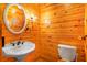 Cozy half bath with a vanity, commode, and wood clad walls and ceiling at 398 W Fisher Rd, Summerville, SC 29483
