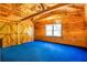 Bedroom with blue carpet, wood paneled walls, wood ceiling, and closet with barn doors at 398 W Fisher Rd, Summerville, SC 29483