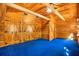 Bedroom with blue carpet, wood paneled walls, wood ceiling, and closet with barn doors at 398 W Fisher Rd, Summerville, SC 29483