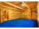 Wood paneled bedroom with blue carpet, wood ceiling, barn doors, and a ceiling fan at 398 W Fisher Rd, Summerville, SC 29483