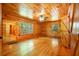Wood paneled bedroom with wood floors, windows, and doors with barn-style hardware at 398 W Fisher Rd, Summerville, SC 29483