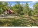 Spacious yard with a log-cabin style home and a pond at 398 W Fisher Rd, Summerville, SC 29483