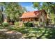 Beautiful log home with metal roof, covered porch and lush green yard with mature trees at 398 W Fisher Rd, Summerville, SC 29483
