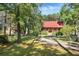 Secluded log cabin home with a barn and a lush green yard at 398 W Fisher Rd, Summerville, SC 29483