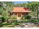 Charming log cabin with a covered porch and neatly manicured landscaping at 398 W Fisher Rd, Summerville, SC 29483