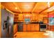 Modern kitchen with stainless steel appliances, wooden cabinets, and black countertops at 398 W Fisher Rd, Summerville, SC 29483