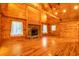 Spacious wood-clad living room with a stone fireplace and abundant natural light at 398 W Fisher Rd, Summerville, SC 29483