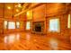 Expansive living room with cathedral ceiling, wood floors, stone fireplace, and bright windows at 398 W Fisher Rd, Summerville, SC 29483