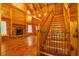 Spacious room with a stone fireplace, wood floors, ceilings, and a staircase at 398 W Fisher Rd, Summerville, SC 29483