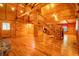 Spacious living room with loft, staircase, and a stone fireplace in this wood paneled home at 398 W Fisher Rd, Summerville, SC 29483