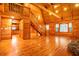 Open-concept living room with wood floors, cathedral ceiling, staircase, and natural light at 398 W Fisher Rd, Summerville, SC 29483