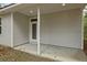 Back porch featuring a concrete floor and a white door with a window at 4013 A Ladson Rd, Ladson, SC 29456