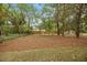 Wide shot of backyard with wooded area and a privacy fence in the background at 4013 A Ladson Rd, Ladson, SC 29456