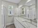 Bathroom featuring a double sink vanity, mirror, and shower with natural light at 4013 A Ladson Rd, Ladson, SC 29456