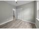 Neutral bedroom with wood-look floors leading to white doors and bathroom access at 4013 A Ladson Rd, Ladson, SC 29456