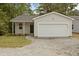 Charming single-story home featuring a one-car garage and gravel driveway at 4013 A Ladson Rd, Ladson, SC 29456
