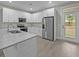Modern kitchen featuring stainless steel appliances, granite countertops, and white cabinets at 4013 A Ladson Rd, Ladson, SC 29456