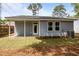 View of the home's backyard featuring a covered patio, lush grass, and well-maintained landscaping at 4013 B Ladson Rd, Ladson, SC 29456