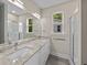 Well-lit double vanity bathroom features granite countertops, framed mirror, and glass-enclosed shower at 4013 B Ladson Rd, Ladson, SC 29456