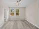 Bedroom with two windows overlooking trees, ceiling fan, and view to a bathroom at 4013 B Ladson Rd, Ladson, SC 29456