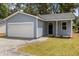 Charming one-story home featuring blue siding, a one-car garage, and a gravel driveway at 4013 B Ladson Rd, Ladson, SC 29456