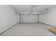 A well lit two car garage with white walls and ceiling, an automatic door, and concrete floors at 4013 B Ladson Rd, Ladson, SC 29456