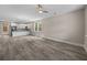 Open-concept living room with gray flooring, modern lighting, and an adjacent white kitchen at 4013 B Ladson Rd, Ladson, SC 29456