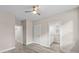 Neutral paint and light hardwood-style floors compliment this lovely bedroom with a ceiling fan and open ensuite at 4013 B Ladson Rd, Ladson, SC 29456