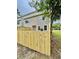 Fenced backyard showcasing the home's exterior and a neatly maintained outdoor space at 4114 Babbitt St, Charleston, SC 29414