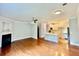 Open-concept living room with hardwood floors, fireplace, and kitchen access at 4114 Babbitt St, Charleston, SC 29414