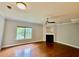 Bright living room with hardwood floors, ceiling fan, large window, and fireplace at 4114 Babbitt St, Charleston, SC 29414