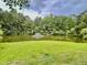 Scenic view of a tranquil pond surrounded by lush trees and a well-manicured lawn at 4114 Babbitt St, Charleston, SC 29414