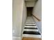 Staircase with painted steps and a wooden handrail, providing a modern touch at 4114 Babbitt St, Charleston, SC 29414