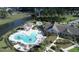 Aerial view of community pool with lake view, pool house, and outdoor seating areas at 423 Four Seasons Blvd, Summerville, SC 29486