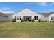 Well-manicured backyard featuring lush lawn, patio area, and charming rear home exteriors at 423 Four Seasons Blvd, Summerville, SC 29486
