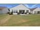 Spacious backyard showcasing a well-maintained lawn, a patio area, and rear exteriors of homes at 423 Four Seasons Blvd, Summerville, SC 29486