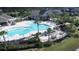 Community pool with plenty of lounge chairs and tables surrounded by well-maintained landscaping at 423 Four Seasons Blvd, Summerville, SC 29486