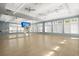 Bright and airy fitness studio with mirrored wall, ceiling fans, and wood-look floors at 423 Four Seasons Blvd, Summerville, SC 29486