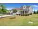Well-manicured front lawn with mature tree and landscaping leading to a lovely home at 423 Four Seasons Blvd, Summerville, SC 29486
