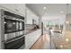 Modern kitchen featuring stainless steel appliances, granite countertops, and white cabinetry at 423 Four Seasons Blvd, Summerville, SC 29486