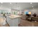 Open floor plan featuring kitchen island with granite countertops, sink and pendant lights at 423 Four Seasons Blvd, Summerville, SC 29486