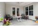 Inviting covered patio featuring a ceiling fan, comfortable seating, and a peaceful outdoor space at 423 Four Seasons Blvd, Summerville, SC 29486