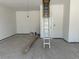 A bare, freshly painted garage features an access ladder to the attic and clean, spacious layout at 428 Evening Glow Ln, Summerville, SC 29486