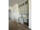 Bright eat-in kitchen features white cabinets, stainless sink, and stone countertops, perfect for meal preparation at 428 Evening Glow Ln, Summerville, SC 29486