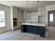 This spacious kitchen features white cabinets, a large island, and modern appliances, providing ample room for cooking at 428 Evening Glow Ln, Summerville, SC 29486