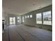 Spacious living room boasts natural light, neutral color palette, and sliding glass door to the outdoors at 428 Evening Glow Ln, Summerville, SC 29486